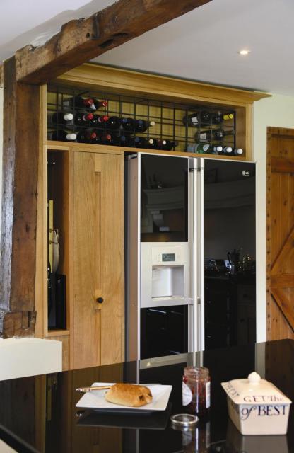 Fridge Freezer Surround with Pull-out Larder in Solid Natural Oak.