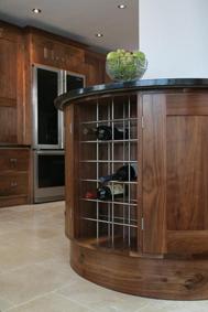 Round Peninsular unit and Fridge Freezer Surround. In Solid Black Walnut.